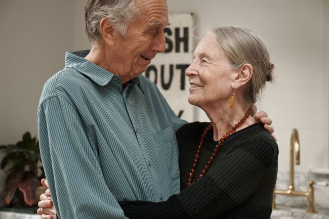 stop-ageism-couple-hugging-kitchen